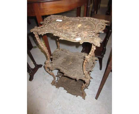 19th Century French cast iron three tier stand decorated with figures and cherubs in attendance playing music in a garden on 