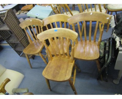A set of four light wood slat back kitchen chairs