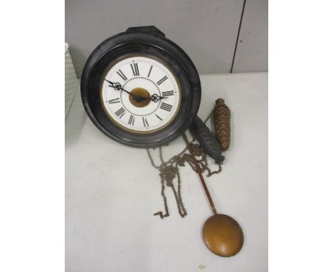 A late 19th century black painted postman's alarm clock 