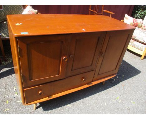 A mid 20th century light Ercol side cabinet having three cupboard doors and a drawer below 32"h x 45" 