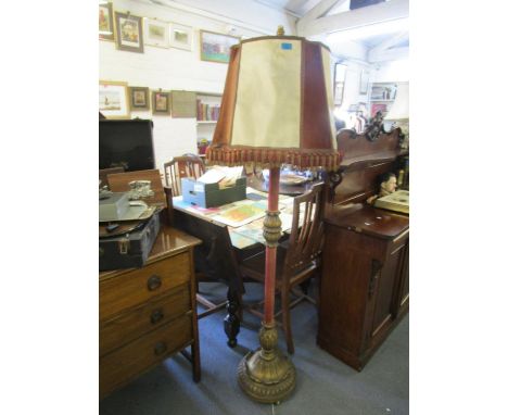 A mid 20th century painted wooden standard lamp with brass fittings and matching parchment and fabric shade 