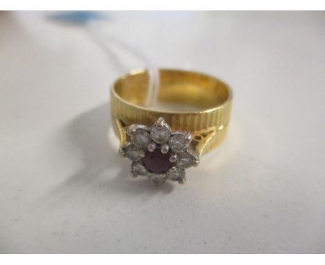 An 18ct gold ring set with a ruby and diamonds 7.1g 