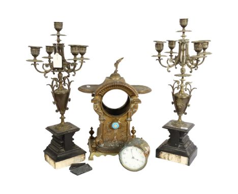 Art Nouveau embossed brass mantel clock with eagle pediment, height 35cm, and a pair of 5-branch brass candelabra on plinths 