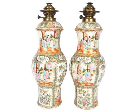 A pair of large Chinese Canton famille rose ceramic baluster oil lamps, with hand painted and enamelled figures in courtyard 