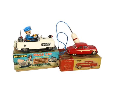 A tinplate battery powered Mystery Police car, in original box, and a Wells Brimtoy Vauxhall electric cable remote control ca
