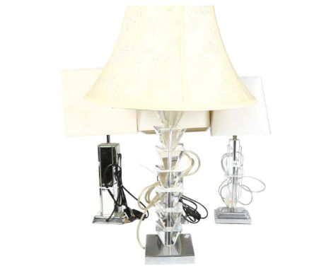 A pair of table lamps with mirrored glass columns and cream shades, height 55cm overall, a table lamp with perspex column and