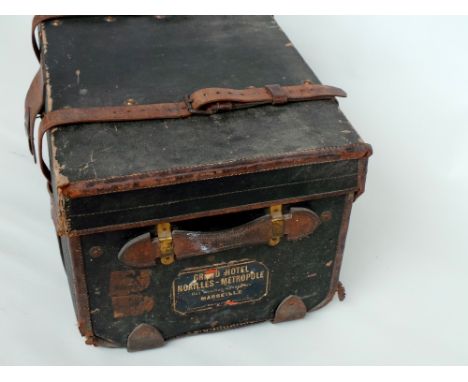 A large leather bound and strapped Army & Navy Stores trunk, stamped M 3793 on the leather front flap and with a Grande Hotel