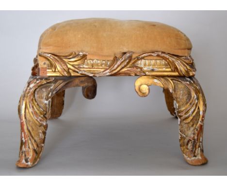 An 18th century gilt wood floor stool on foliate carved frame