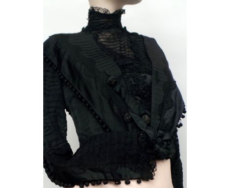 A black silk and lace Victorian bodice with beautiful detailing and covered button embellishment running down the sleeves and