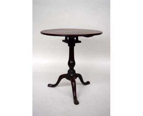 A George III mahogany bird cage action tripod table, circular top over turned stem and splayed legs, 64cmD