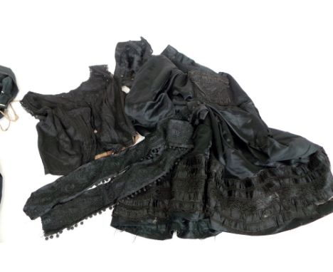 A lot of black silk and cotton Victorian dress pieces - a skirt, a bodice, two undergarments,  wool cloak and two what appear