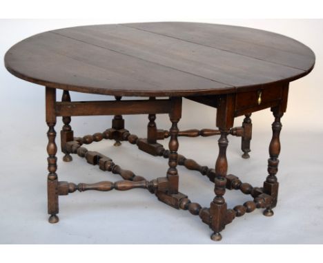 An oak gate leg table of large size with end drawer on baluster turned frame 130cmW x 74cmH