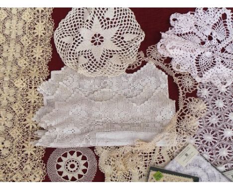 A quantity of vintage crocheted and linen tableware and coasters including Nottingham lace pieces. Five wool crocheted tea co