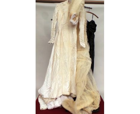 A 1962 ivory velvet wedding dress and veil. Dress lovely though quite damaged (nibbled) and has some pink stain to the hem, t