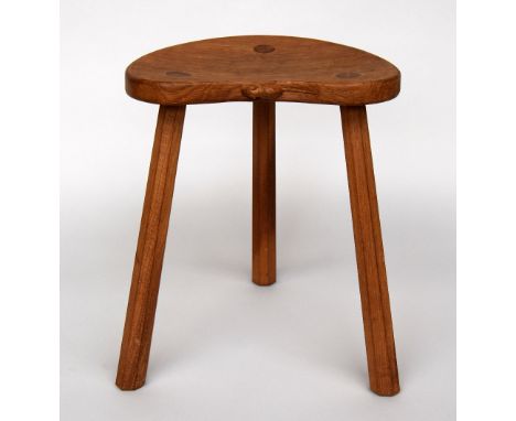 A Robert Thompson of Kilburn 'Mouseman' oak tripod milking stool with tapering legs, signed with carved mouse to back of seat