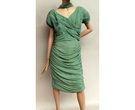 1950s ruched chiffon fitted dress in pale grey-green. The garment is lined with a back metal zip and features a chiffon drape