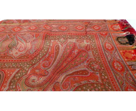 A vintage paisley shawl measuring 1.60m x 1.85m nice clean condition though with a 12cm tear to outside edge, smaller tear to