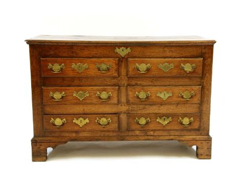 A George III oak Lancashire mule chest, the hinged lid above an arrangement of four faux drawers and two short base drawers, 