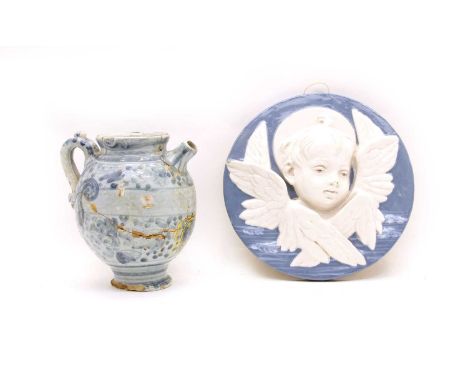 A Della Robbia style plaque of a cherub, and an 18th century apothecary jar