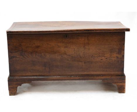 An elm blanket box, 19th century, the lid with cleated ends, the sides and front with dovetailed joints, and on bracket feet,