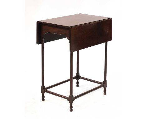 A George III style mahogany spider-leg Pembroke table, 20th century, with a shaped frieze and slender turned, supports united