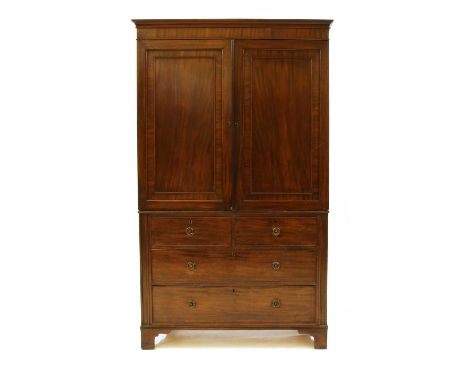 A 19th century mahogany hanging cupboard,with two panelled doors over two faux drawers, two long drawers and bracket feet, fo