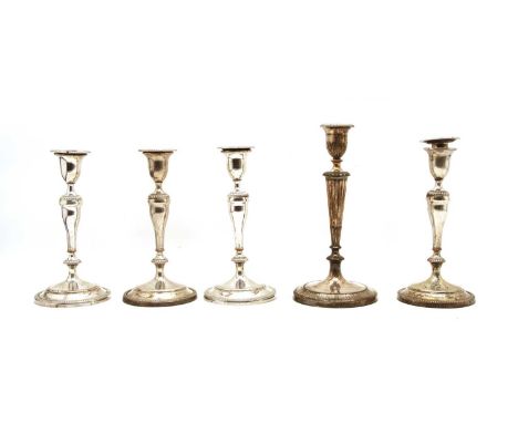 A set of four silver plated candlesticks, having vase shaped columns, 25cm high, and a single candlestick, 29cm high (5)