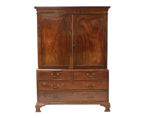 A mahogany linen press, early to mid 19th century, the upper section with Greek key moulding, over twin panelled doors, the l