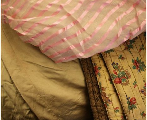 A travelling trunk containing a 19th Century Welsh quilt in golds and reds, a Georgian gentleman's striped waistcoat, a Georg