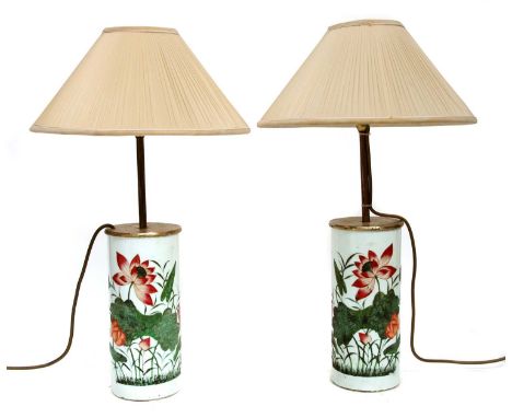 A pair of Chinese porcelain table lamps, 20th century, of cylindrical form, painted in enamels with lotus flowers, each beari