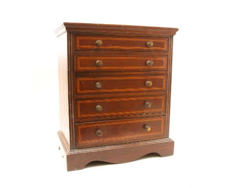 A late 19th Century inlaid mahogany 'apprentice piece' miniature chest of drawers, the satinwood and ebony inlaid rectangular