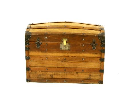 A dome topped trunk, having metal mounts, and twin carry handles, 65cm high, 87cm long