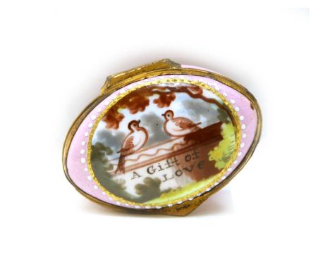 A pink enamel patch box, 19th century, of oval shape, the hinged cover painted with two doves and inscribed 'A Gift of Love',