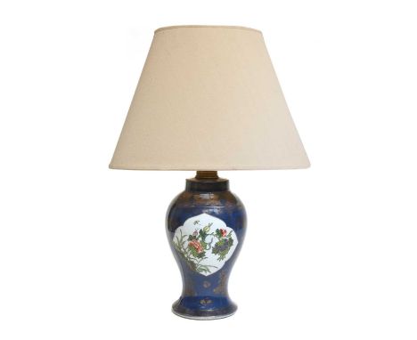 A Chinese porcelain table lamp, late 19th/early 20th century, of baluster form, with shaped panels, painted in enamels with p