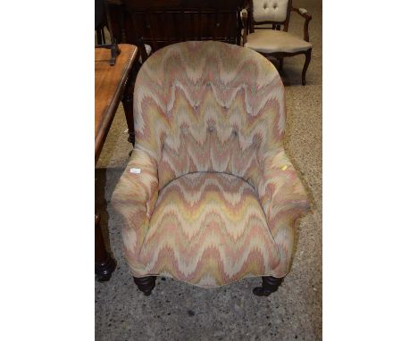 Button backed upholstered armchair on turned legs and casters