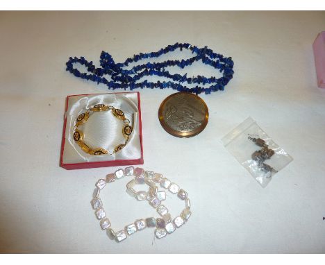 Selection of costume jewellery, compact, necklaces etc