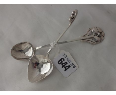 Georg Jensen style caddy spoon and another, each  marked solid silver, 38g.      