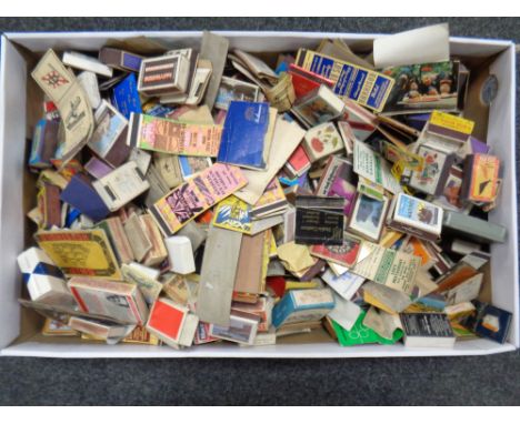 A box of vintage match books and match boxes