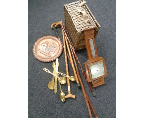 A box of wicker picnic hamper, brass plaque, copper items, walking sticks, barometer etc 