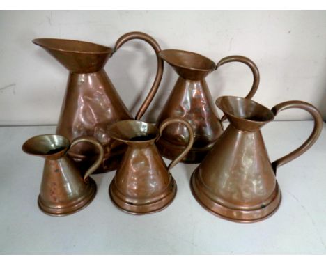 A vintage set of five graduated Victorian copper measuring jugs.  (5)   CONDITION REPORT: Tallest 31 cm down to the smallest 