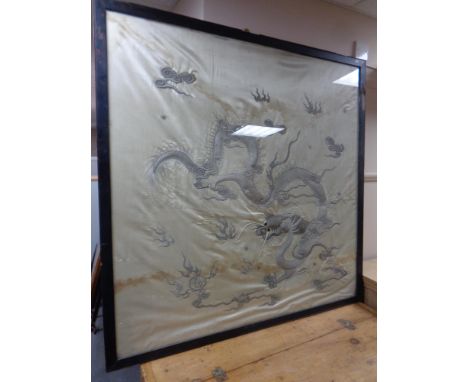 A large silk embroidered panel depicting dragon in frame.