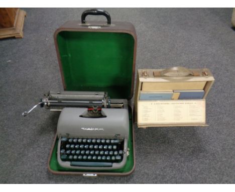 A vintage Remington typewriter in case together with a mid century Linguaphone set 
