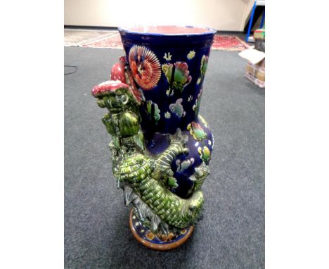A Majolica style stick pot surmounted by a dragon  