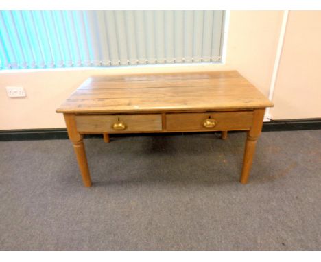 A light oak two drawer table, width 122 cm  