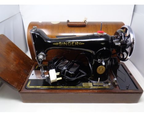 A vintage Singer electric sewing machine in case, in case,  with the  extension panel. 