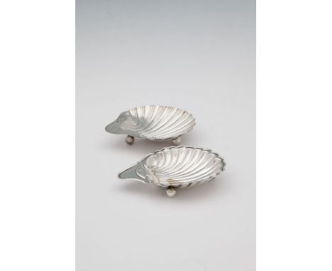 A SILVER SCALLOP SHELL BUTTER DISH, Sheffield 1897, mark of M.W, possibly Millar Wilkinson, raised on spherical feet. 13.5cm 