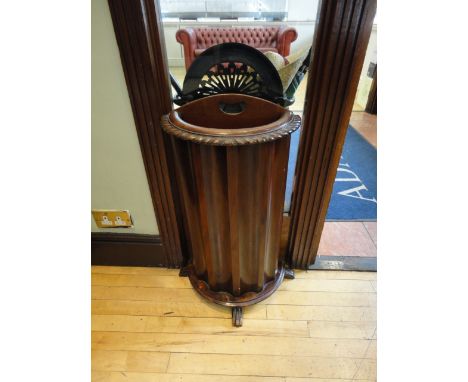 A GEORGIAN STYLE MAHOGANY DEMI-LUNE STICK STAND, with pierced handle and moulded gadroon rim.