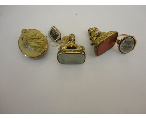 A VICTORIAN LAVA BROOCH, depicting a lady in high relief within a yellow metal surround.