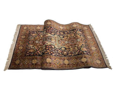 AN INDIAN HAND-KNOTTED KASHMIR RUNNER, Contemporary, of oblong shape, the navy ground reserve woven with interlinked floral m