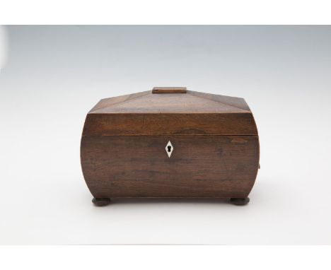 A WILLIAM IV ROSEWOOD SARCOPHAGUS SHAPED TEA CADDY, the hinged lid opening to reveal twin lidded compartments, with mixing bo